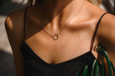 Chain with a ring on the chest of a beautiful girl