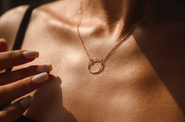 Chain with a ring on the chest of a beautiful girl