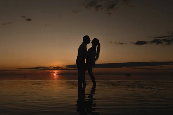 海の近くの日没の背景にロマンチックなカップル 海に沿って日没の散歩 — ストック写真