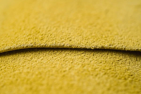 Yellow roll of genuine leather. Wallpaper. Yellow leather for shoes and bags