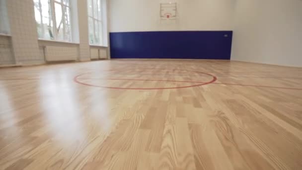 Empty school basketball hall with big windows — Stock Video