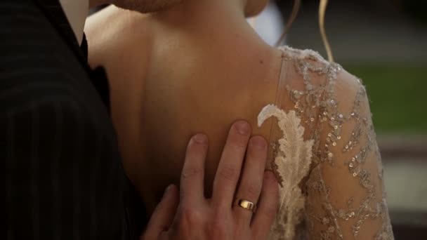 Bride and groom close-up. Groom puts his hand on brides back — Stock Video
