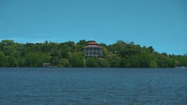 Big house in trees, view from sea