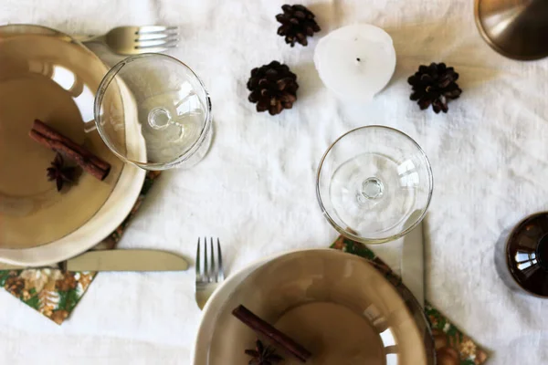 Christmas Dinner Table with Linen Cloth, Kitchenware, Decorations. Christmas, New Year Holidays Celebration at Home.