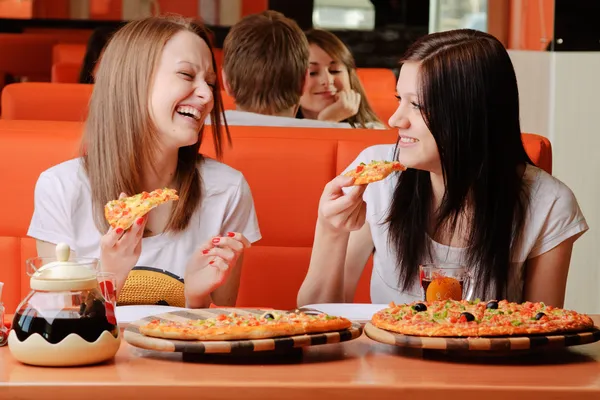 Beautiful young women eating pizza — Stock Photo, Image