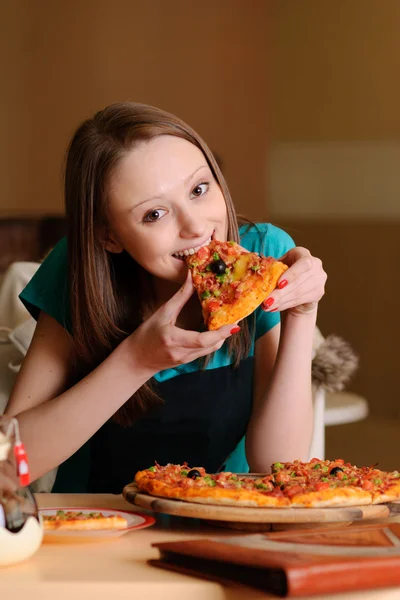 Beautiful college student in pizzeria Stock Image