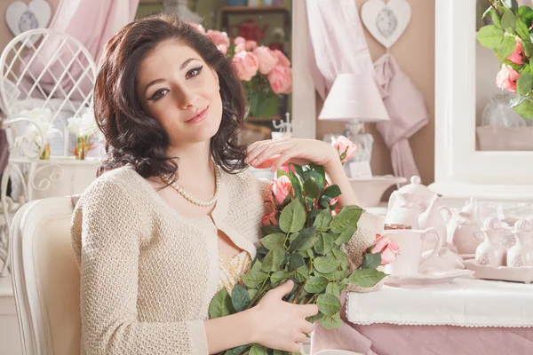 Beautiful young woman with flowers. Retro styled — Stock Photo, Image