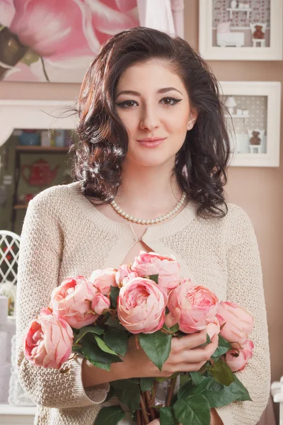 Beautiful young woman with flowers. Retro styled — Stock Photo, Image