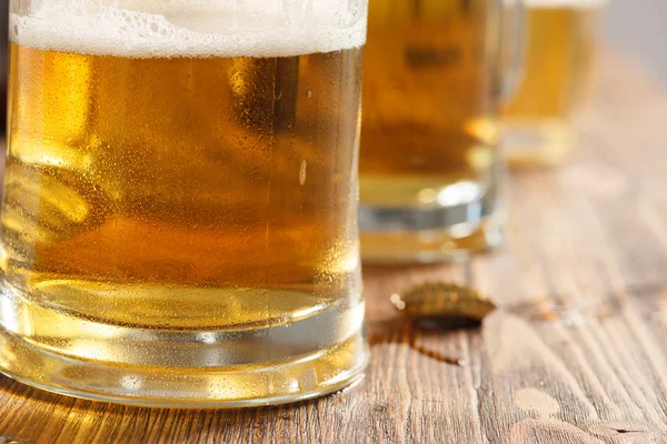 Three cold beer glasses on bar or pub desk — Stock Photo, Image