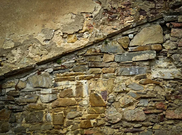 Oude geërodeerde stenen muur — Stockfoto