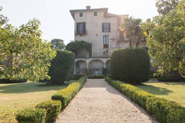 Travel in Italy. Back view of beautiful tourist girl enjoying view of Este Castle Castello Estense of Ferrara, Italy.