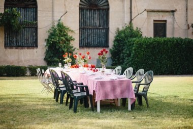Travel in Italy. Back view of beautiful tourist girl enjoying view of Este Castle Castello Estense of Ferrara, Italy.