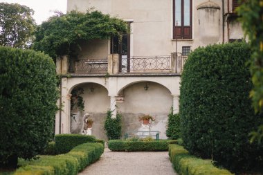 Travel in Italy. Back view of beautiful tourist girl enjoying view of Este Castle Castello Estense of Ferrara, Italy.