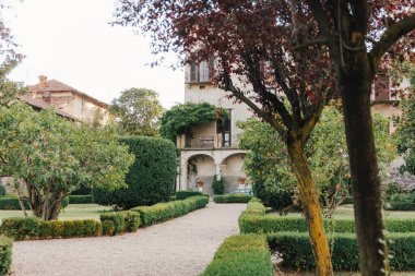 Travel in Italy. Back view of beautiful tourist girl enjoying view of Este Castle Castello Estense of Ferrara, Italy.