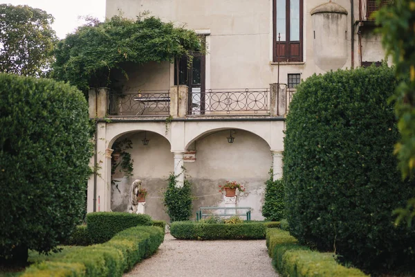 Travel in Italy. Back view of beautiful tourist girl enjoying view of Este Castle Castello Estense of Ferrara, Italy.