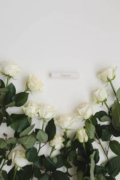 8 de marzo, Día de la Mujer fondo con rosas blancas y lugar para el texto sobre fondo blanco vista superior — Foto de Stock