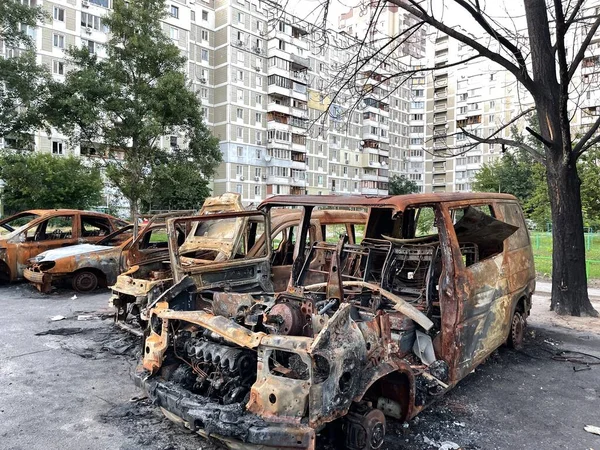 Burnt cars next to a residential building from a rocket hit in Kyiv, Ukraine