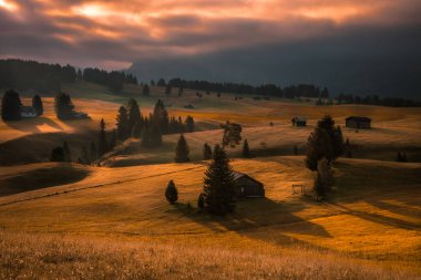 Dolomitlerdeki Seiser Alm dağ çayırında bulutlu bir gün doğumu