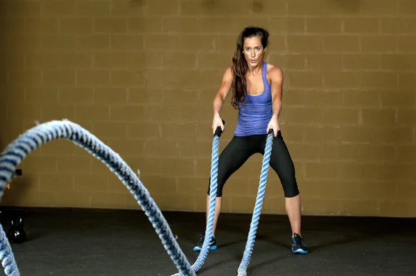 Woman training with atheltic training ropes — Stock Photo, Image