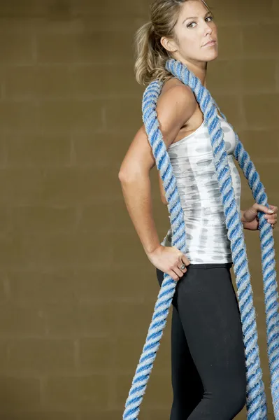 Woman posing with atheltic training ropes — Stock Photo, Image