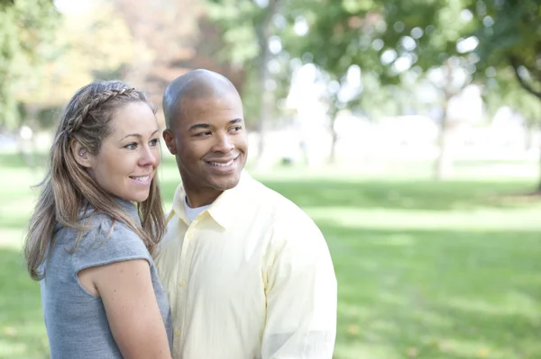 Young interracial couple in the park — Stock Photo, Image