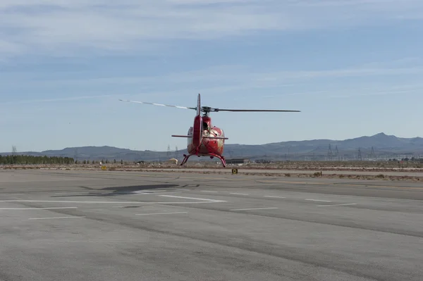 Red helicopter taking off — Stock Photo, Image