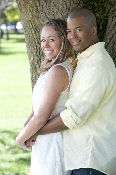 Young interracial couple in the park — Stock Photo, Image