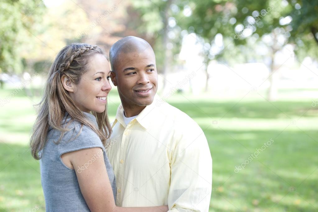 Young interracial couple in the park