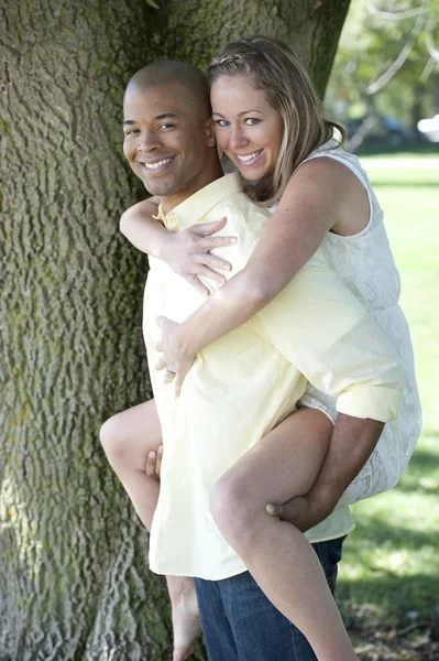 Young interracial couple in the park — Stock Photo, Image