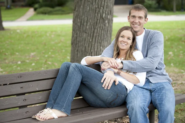 Couple sitting on a bench at the park Stock Photo