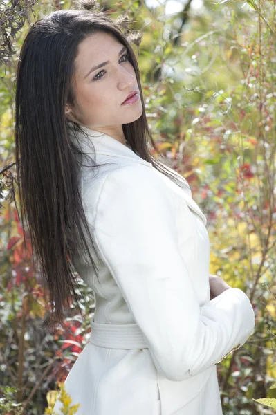 Young girl posing in a white jacket — Stock Photo, Image