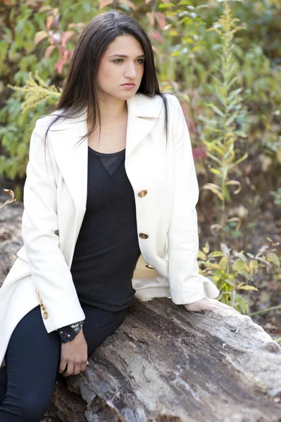 Young girl posing in a white jacket — Stock Photo, Image