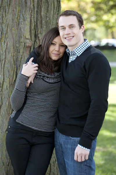 Attractive couple at a park — Stock Photo, Image