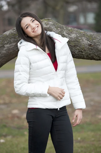 Brunette girl wearing a white puffy coat — Stock Photo, Image