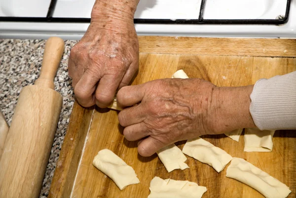 Hands of grandmother at cooking — Stock Photo, Image