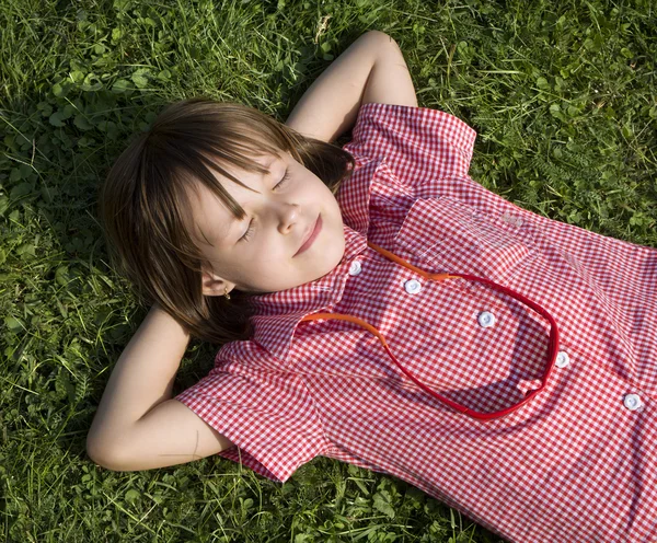 Rust of little girl on the grass — Stock Photo, Image