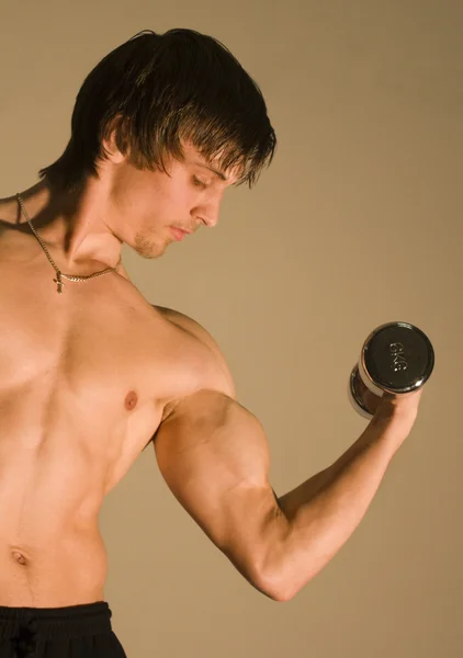 Pose of young bodybuilder — Stock Photo, Image