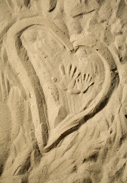 Heart in the sand and the type of hands — Stock Photo, Image