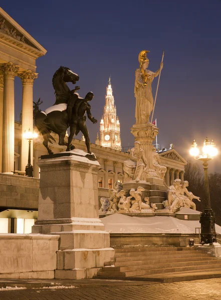 Vienna - Pallas Athena fountain and parliament in winter evening and Town hall tower in background — Stock Photo, Image