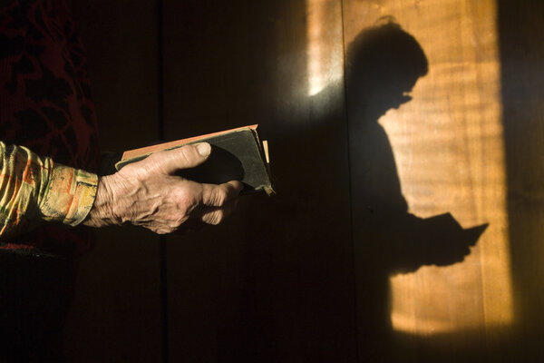 prayer of old woman with the book