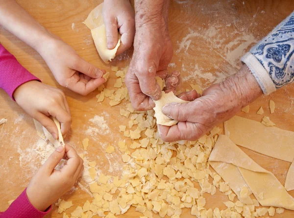 Hands of grandmother and grandchilds at cooking — Stock Photo, Image