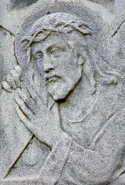 BRATISLAVA - AUGUST 7: Relief of Jesus Christ with the cross from 19. cent. on the tomb in cemetery "Na Kozej brane" on August 7, 2013 in Bratislava, Slovakia. — Stock Photo, Image