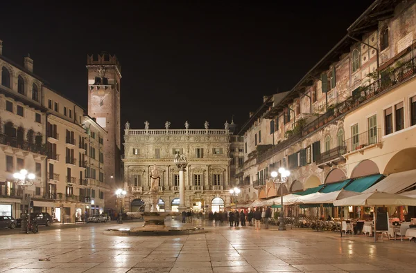 Verona - piazza erbe éjjel és a porta leona és a palazzo maffei, a háttér — Stock Fotó