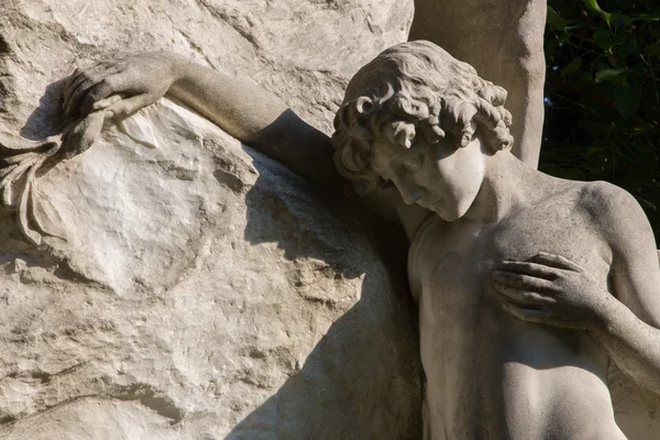 VIENNA - JULY 27: Sadness of young men. Detail from tomb in Centralfriedhoff from 19. cent. on July 27, 2013 Vienna. — Stock Photo, Image