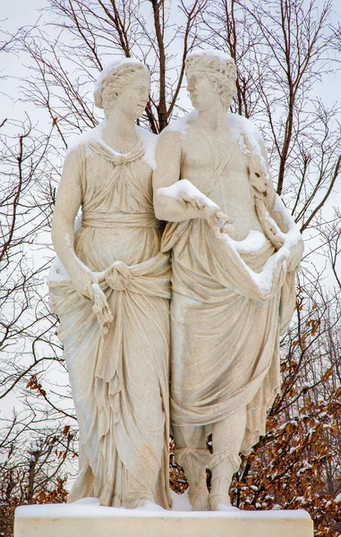 VIENNA - JANUARY 15, 2013: Statue of Ceres and Dionysus from gardens of Schonbrunn palace in winter. Statues was generally made between 1773 and 1780. — Stock Photo, Image