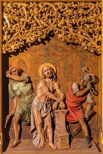 BRATISLAVA, SLOVAKIA - JANUARY 14, 2014: Flagellation of Jesus scene. Carved relief from 19. cent. by Ferdinand Prinoth from St. Ulrich on gothic side altar in st. Martin cathedral. — Stock Photo, Image