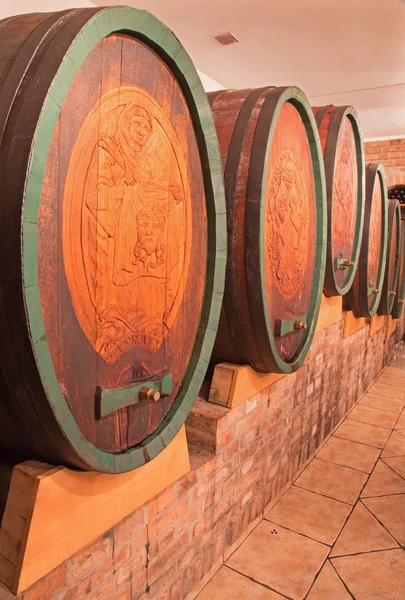 BRATISLAVA, SLOVAKIA - JANUARY 30, 2014: Carved casks in wine cellar of great Slovak producer. — Stock Photo, Image