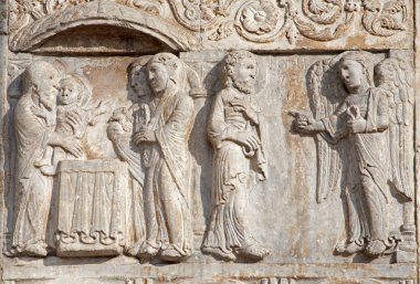 VERONA - JANUARY 27: Presentation of Jesus in the Temple from facade of romanesque Basilica San Zeno. Reliefs is work of the sculptor Nicholaus and his workshop on January 27, 2013 in Verona, Italy. clipart