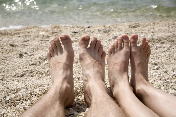 Man and woman feet on the beach - croatia holiday — Stock Photo, Image
