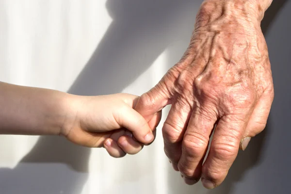 Hand van grootmoeder en kleinkind Stockafbeelding